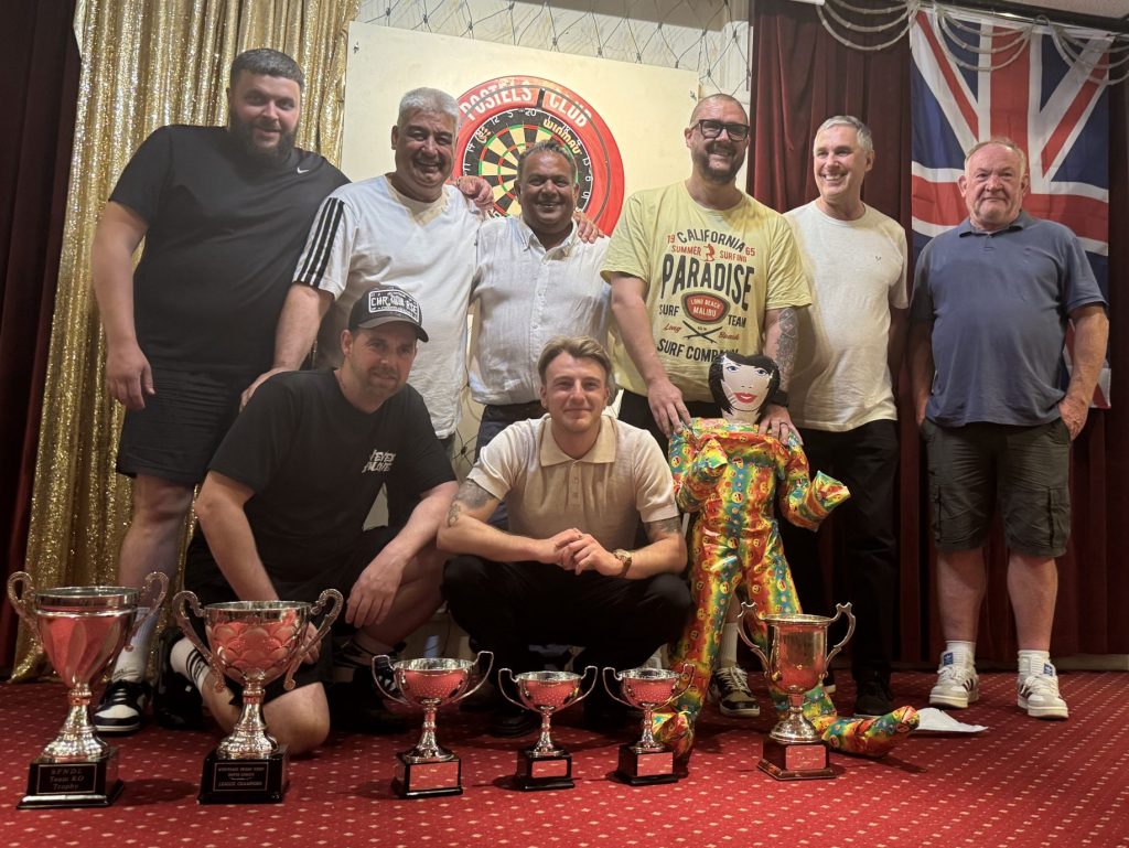 Geleb Trotters team on stage with all of their trophies