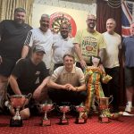 Geleb Trotters team on stage with all of their trophies